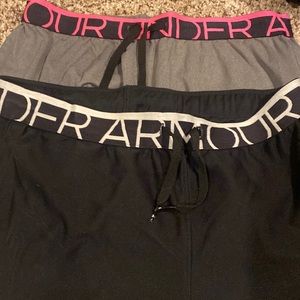Two pair UA shorts. One black one gray